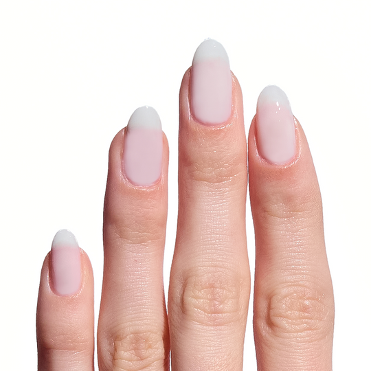 Close-up of a hand with pink nail polish on a white background